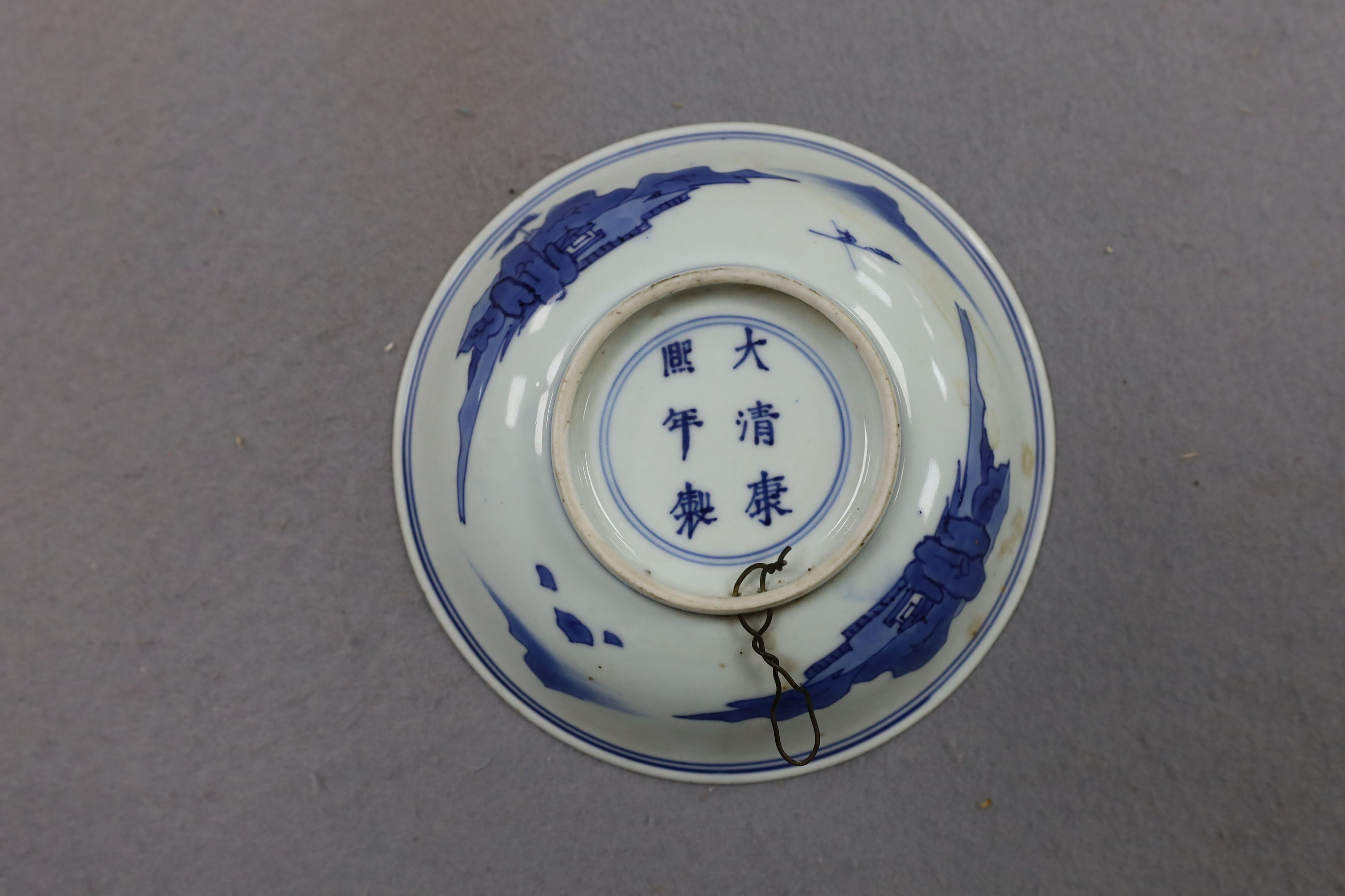 NB BOTH WITH HAIRLINE CRACKS A pair of Chinese blue and white small dishes, Kangxi six character marks and of the period (1662-1722), 15.7cm and 15.8cm diameter, foot later pierced, hairline cracks